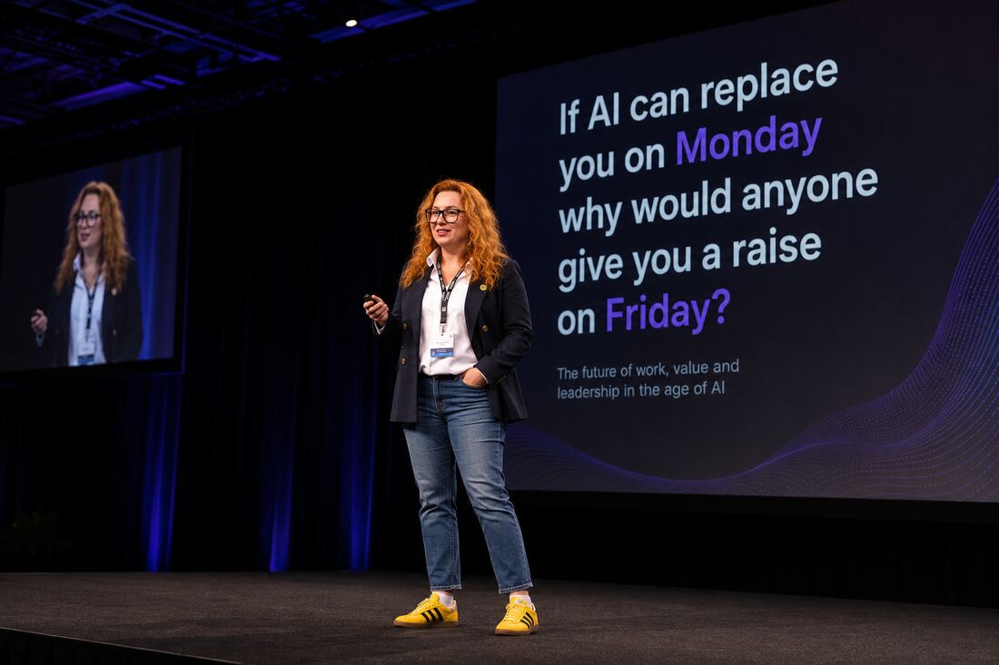 Alisa Reznik speaking on stage to a conference audience